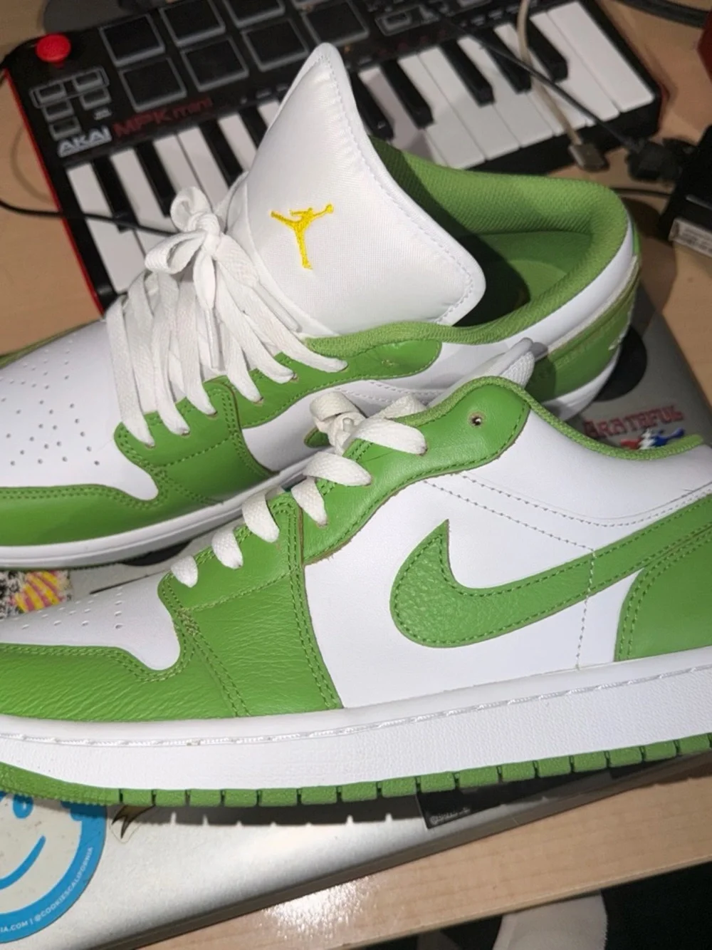 Nike Jordan 1  SE White and Green Low-Top Sneakers with Yellow Logo